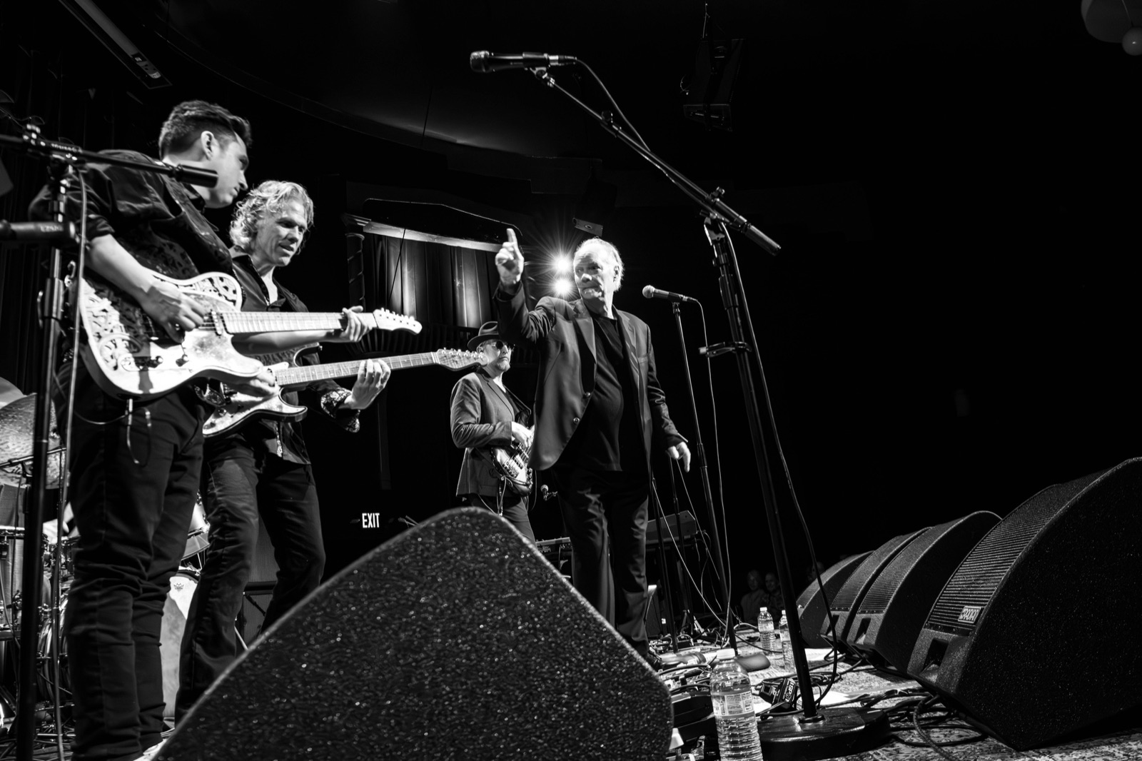 Full band on a starlit theater stage